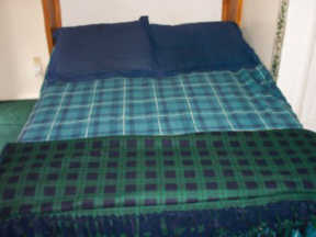 Double bed made with fresh linens and plenty of cozy blankets