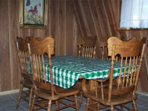 Dining room table seats 6, and there is a bar with 2 barstools.